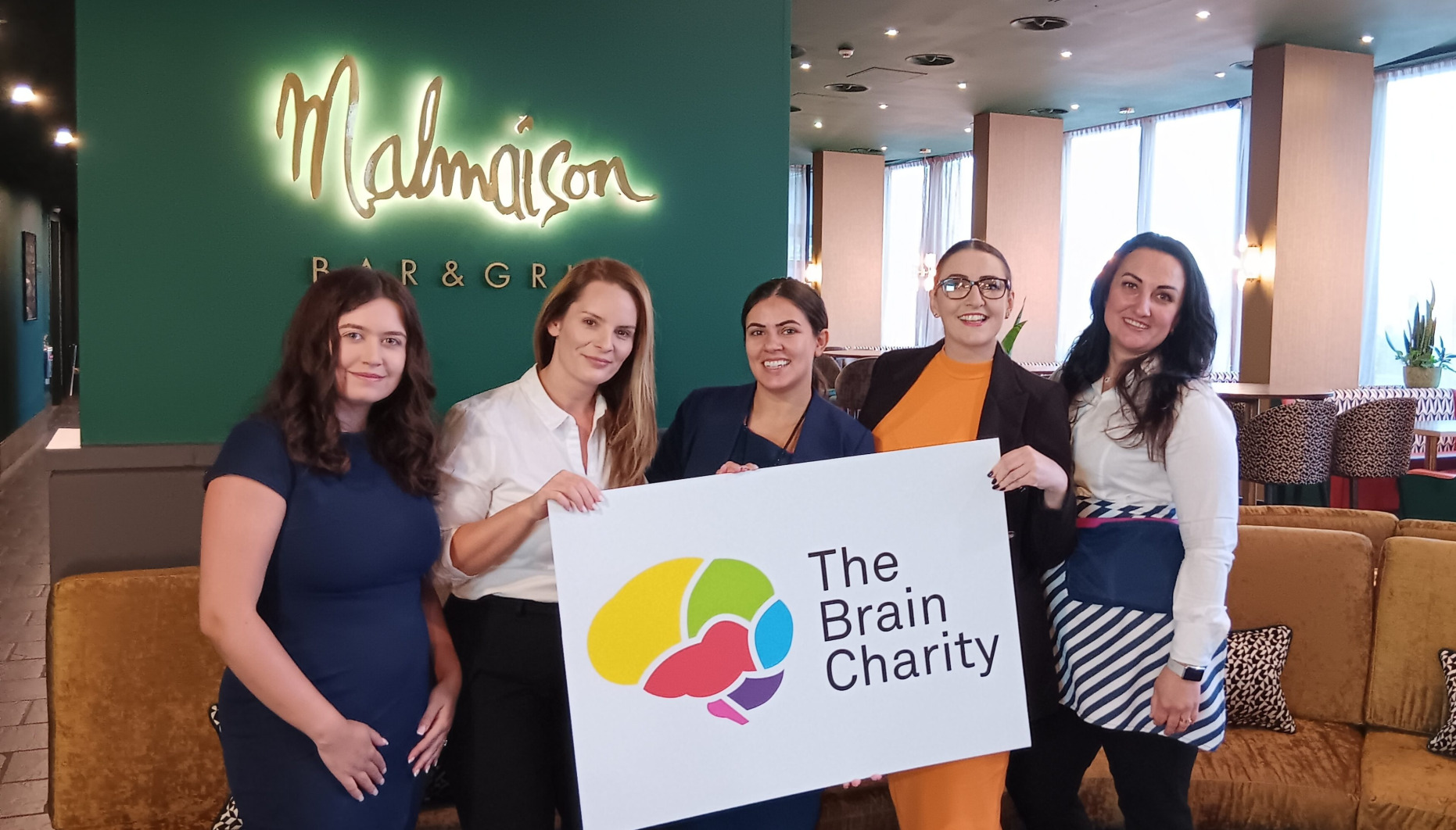 Malmaison Liverpool team hold The Brain Charity's logo
