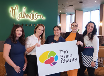Malmaison Liverpool team hold The Brain Charity's logo