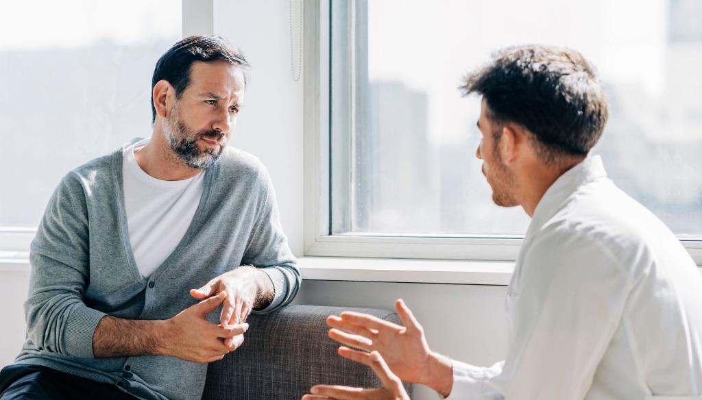 Two men sitting in a room talking