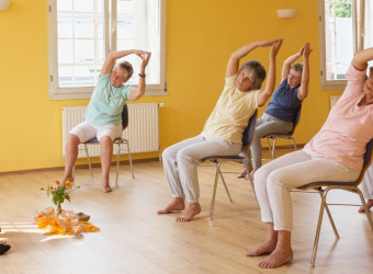 People doing chair yoga with an instructor