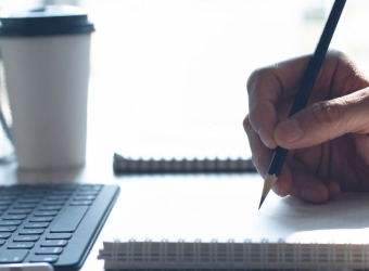 A person writing in a notebook