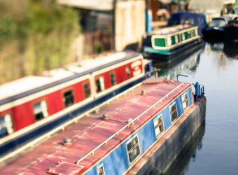 A group of canal boats on a body of water