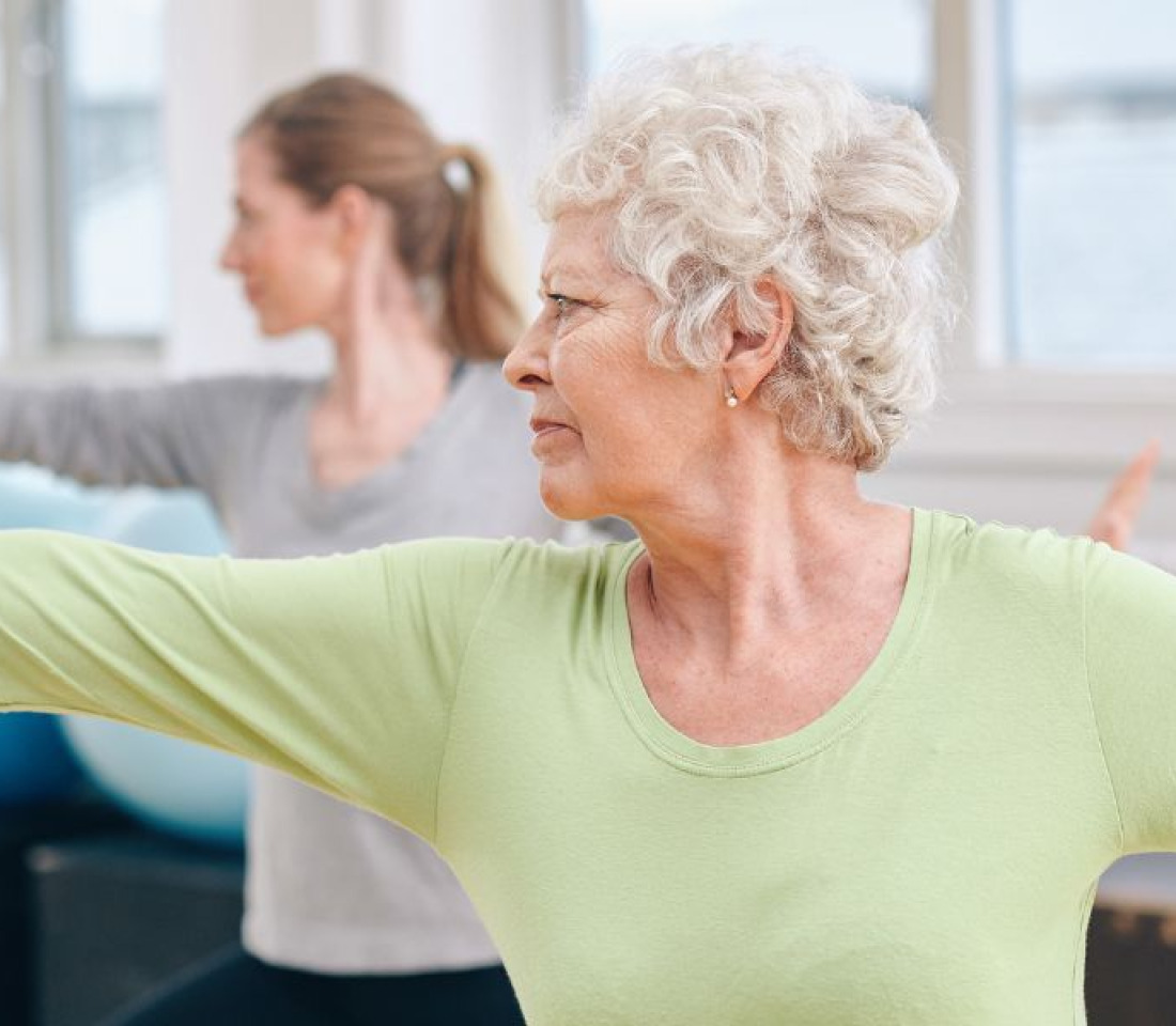 An Older woman exercising with a younger woman