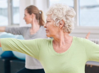 An Older woman exercising with a younger woman