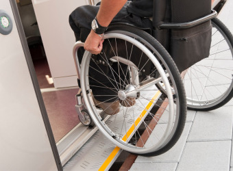 Wheelchair user getting onto a train.