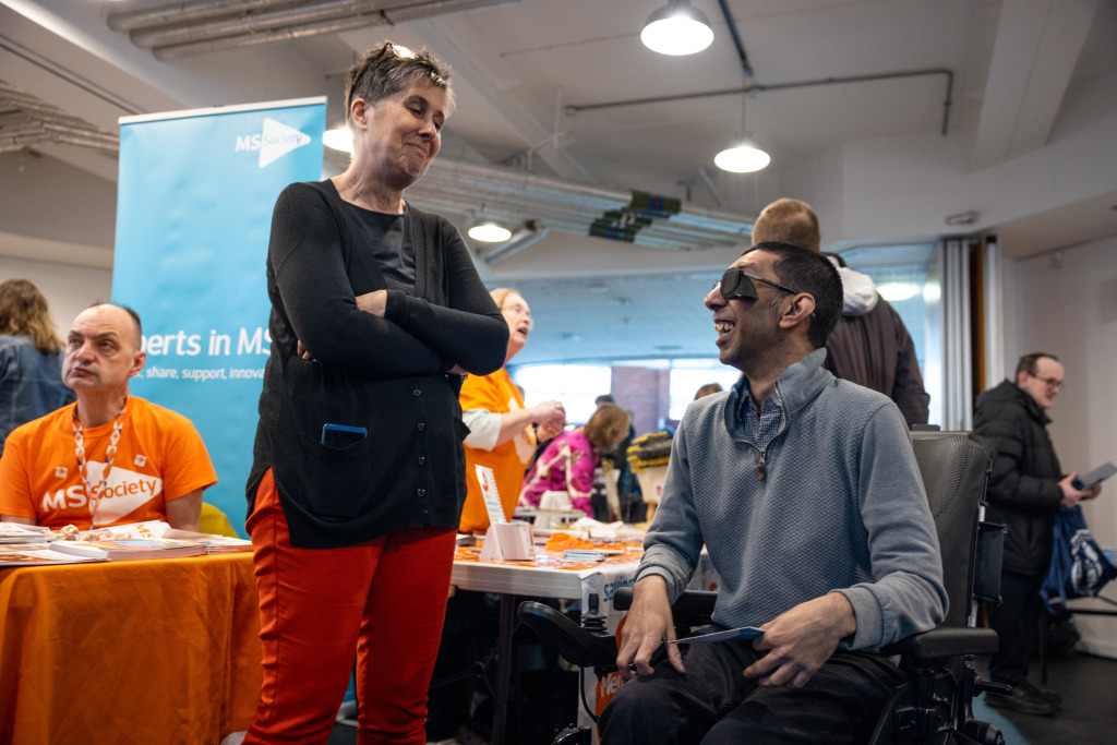 Two people talking besides stalls at The Brain Charity Head Matters 2025 in Liverpool.