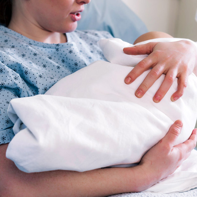 A mother holding a new born baby