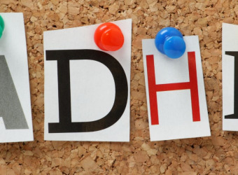 The word ADHD in colourful letters