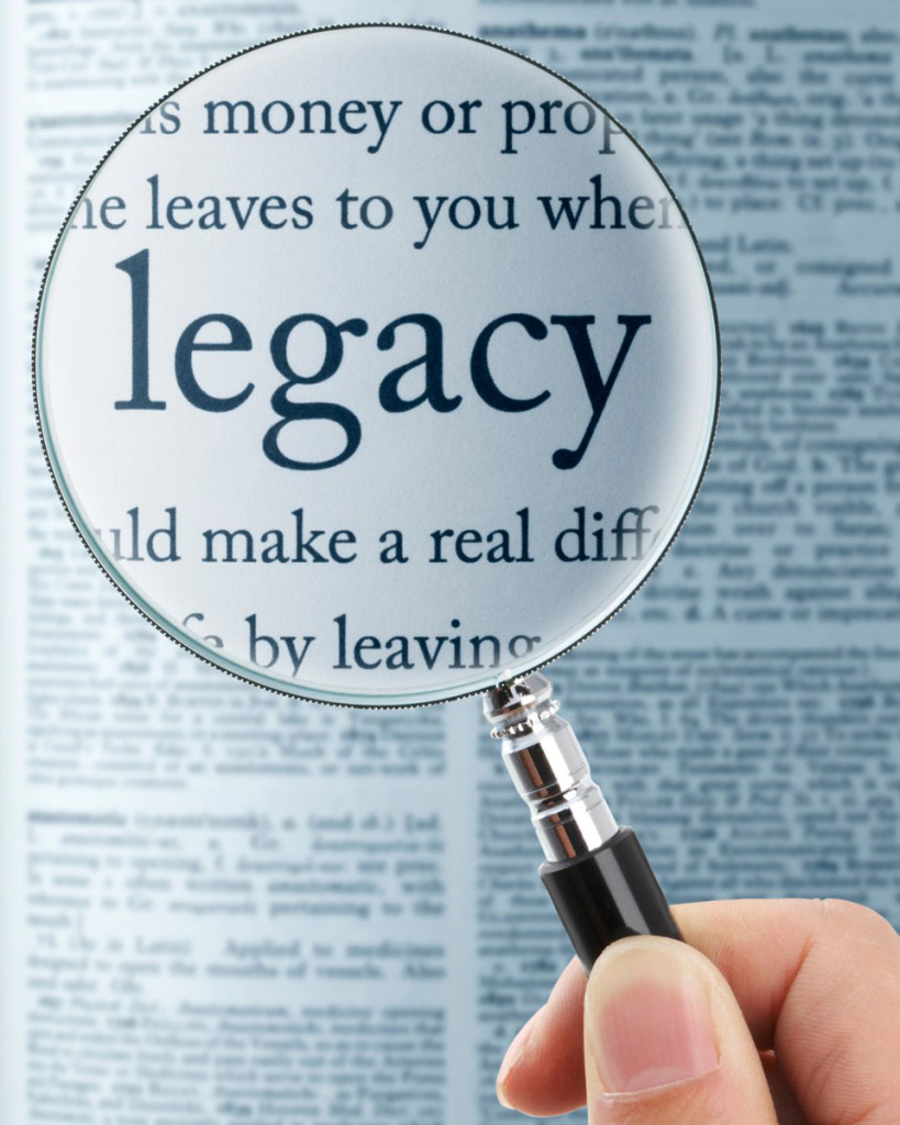 Dictionary page with magnifier highlighting the word legacy