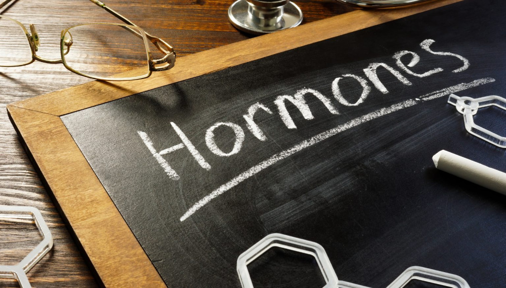 Differing emotion faces drawn in white on black cubes 