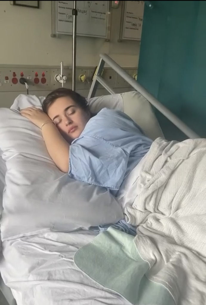 Aisha sleeping in a bed in hospital
