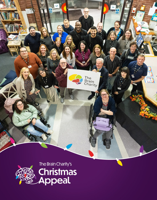 A group of people at The Brain Charity. Overlaid by the words The Brain Charity's Christmas Appeal header image with a brain made from a string of lights.