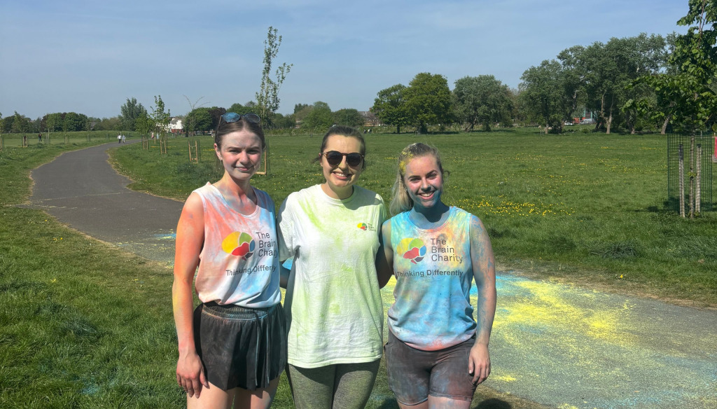 Esme posing with two students at the colour run