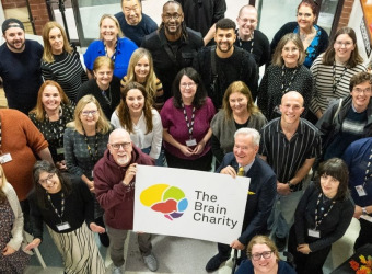 Group of people in The Brain Charity foyer. It includes many staff.