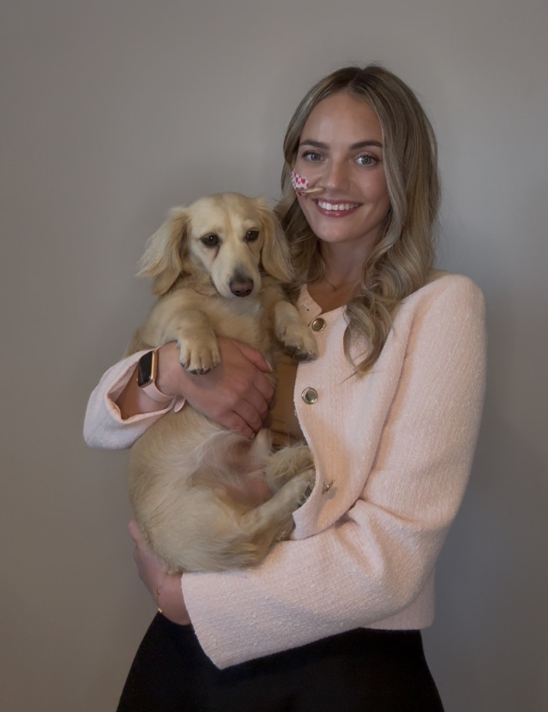 Woman posing for photo wit her dog