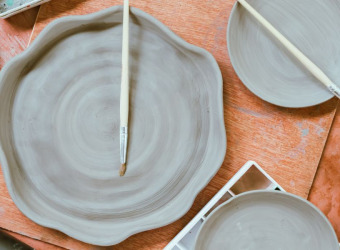 Hand made clay plates drying on a table