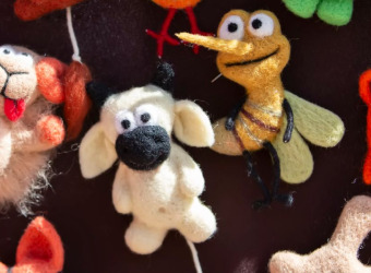 A selection of small hand made soft toys lying on a table