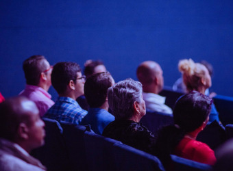 An audience sitting in a room