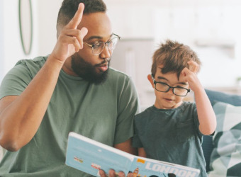 A man and a boy looking at a book