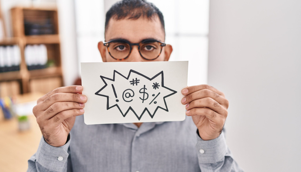 Image of man holding up sign signifying bad language