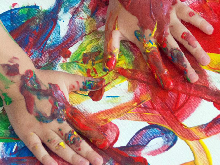 young child hands painting