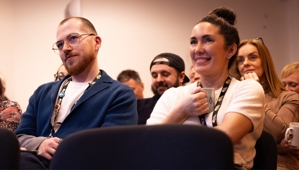 The Brain Charity team member Adam sitting in an audience.