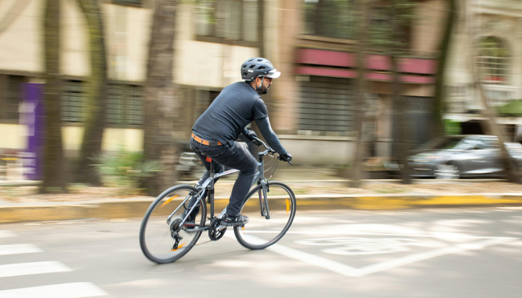 Man riding a bike with a helmet