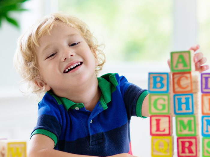 A woman high-fiving a young boy