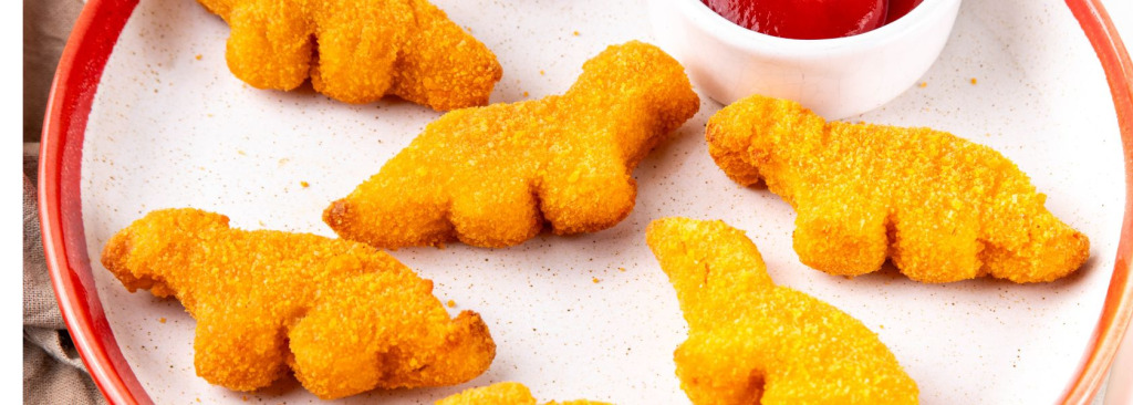 Chicken dinosaurs on a plate with ketchup