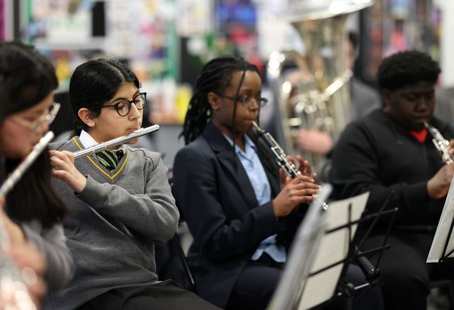 Young people playing wind instruments in an orchestra