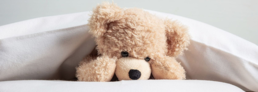 A teddy bear in bed