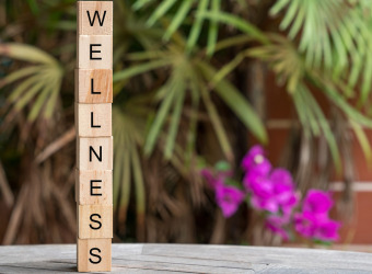 The word wellbeing written on a stack of wooden blocks