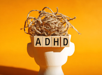Abstract Representation of ADHD with Tangled Threads and Letter Blocks on a White Head Figure, Symbolising Brain Activity and Mental Health