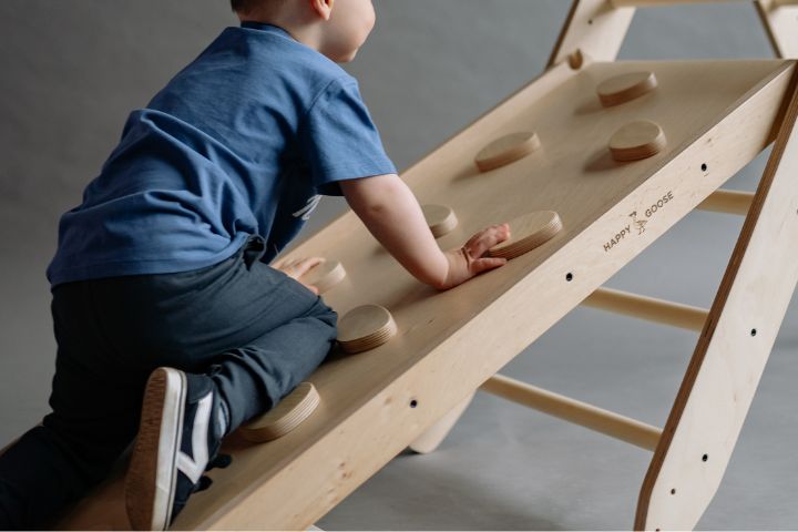 Boy climbing on a climbing frame