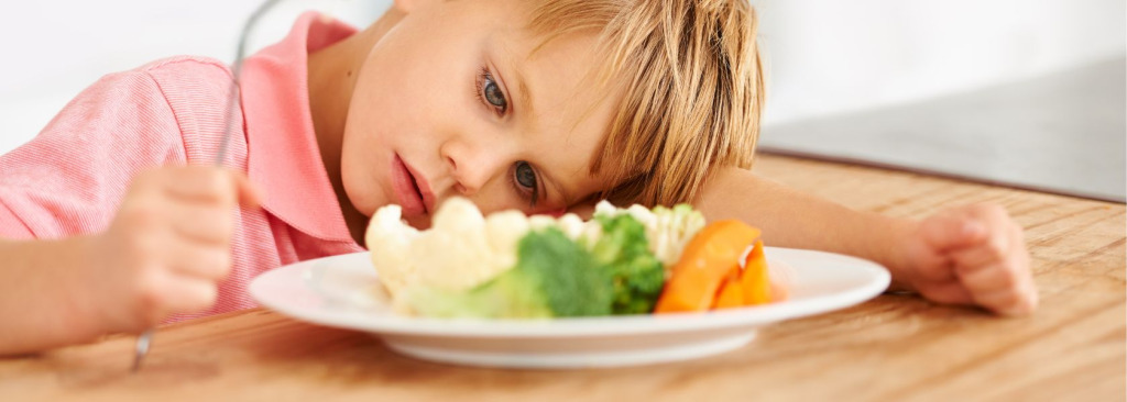 Boy looking at a plate of food