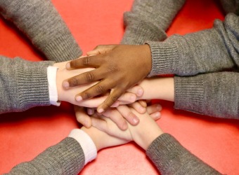 Hands laid atop one another.