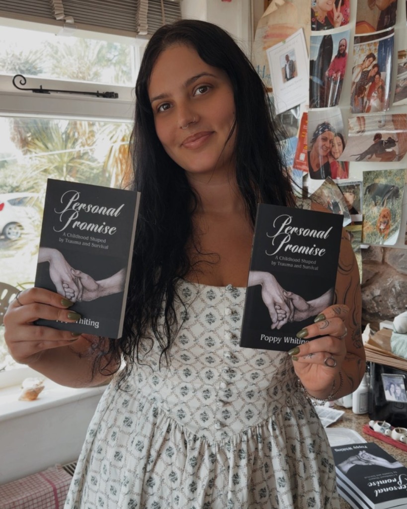 Poppy holding copies of her book