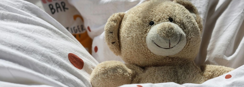 A teddy bear in bed