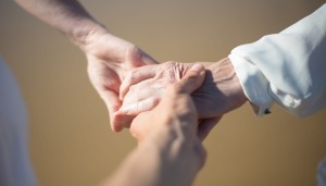 Three people holding hands