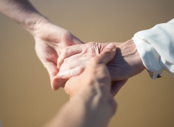 Three people holding hands