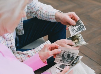 Two people looking at old photographs
