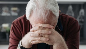 A man with his head in his hands.