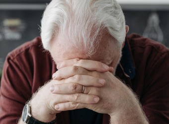 A man with his head in his hands.
