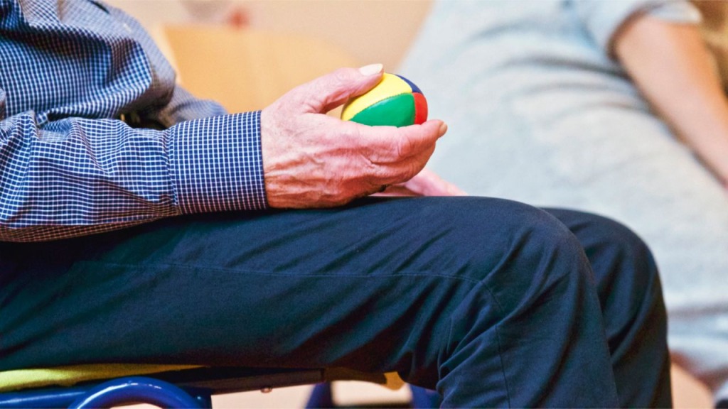 A man holding a colourful ball.
