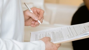 Doctor filling out chart