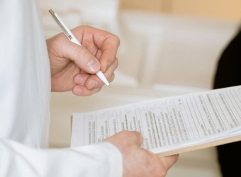 Doctor filling out chart