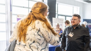 Man and woman talking at a trade show