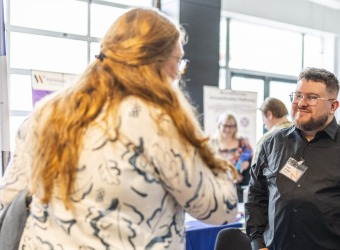 Man and woman talking at a trade show