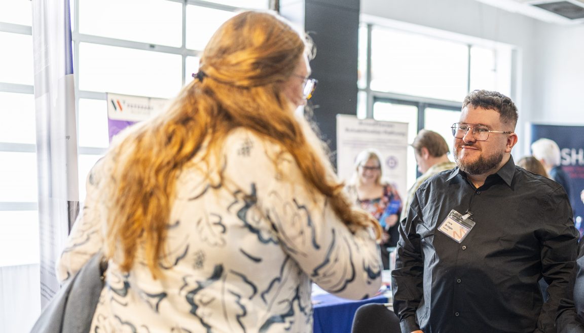 Man and woman talking at a trade show
