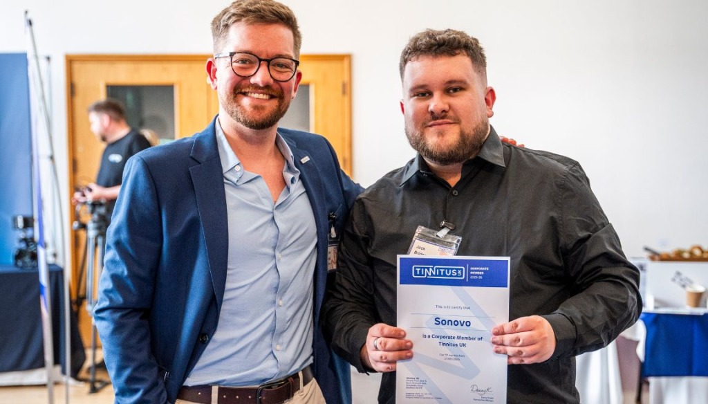 Two men posing with a certificate